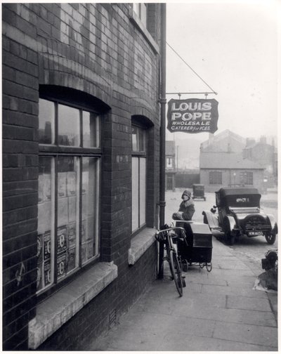 Woman with a Perambulator Outside Louis Popes Premises, Lady Lane, Leeds, 1931 by English Photographer